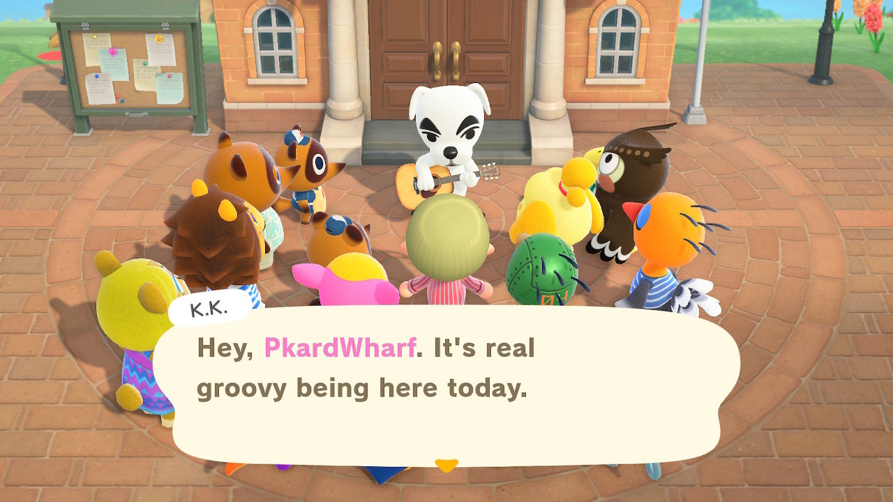 K.K. Slider holding a guitar in the town square with the whole island out to watch