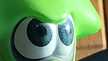 the eyes of a green squid figurine